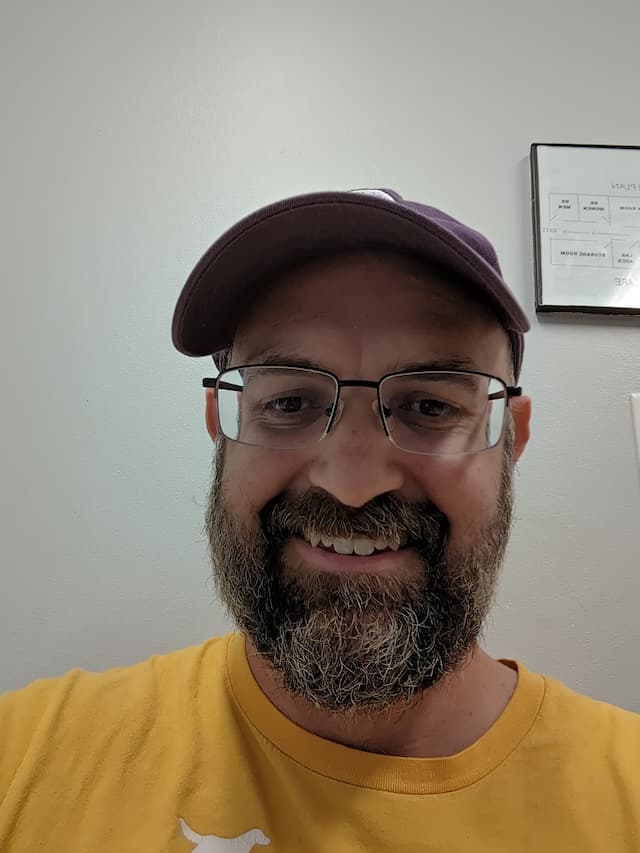 Brian Ramsay selfie wearing a hat wearing a yellowish shirt