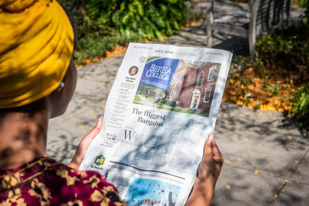 Photo of A Berea College student reading the Wall Street Journal's article ranking Berea College Number 1