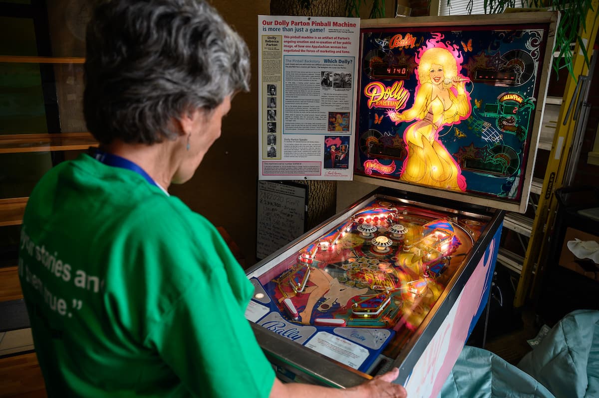 Center visitor playing the Dolly Parton pinball machine