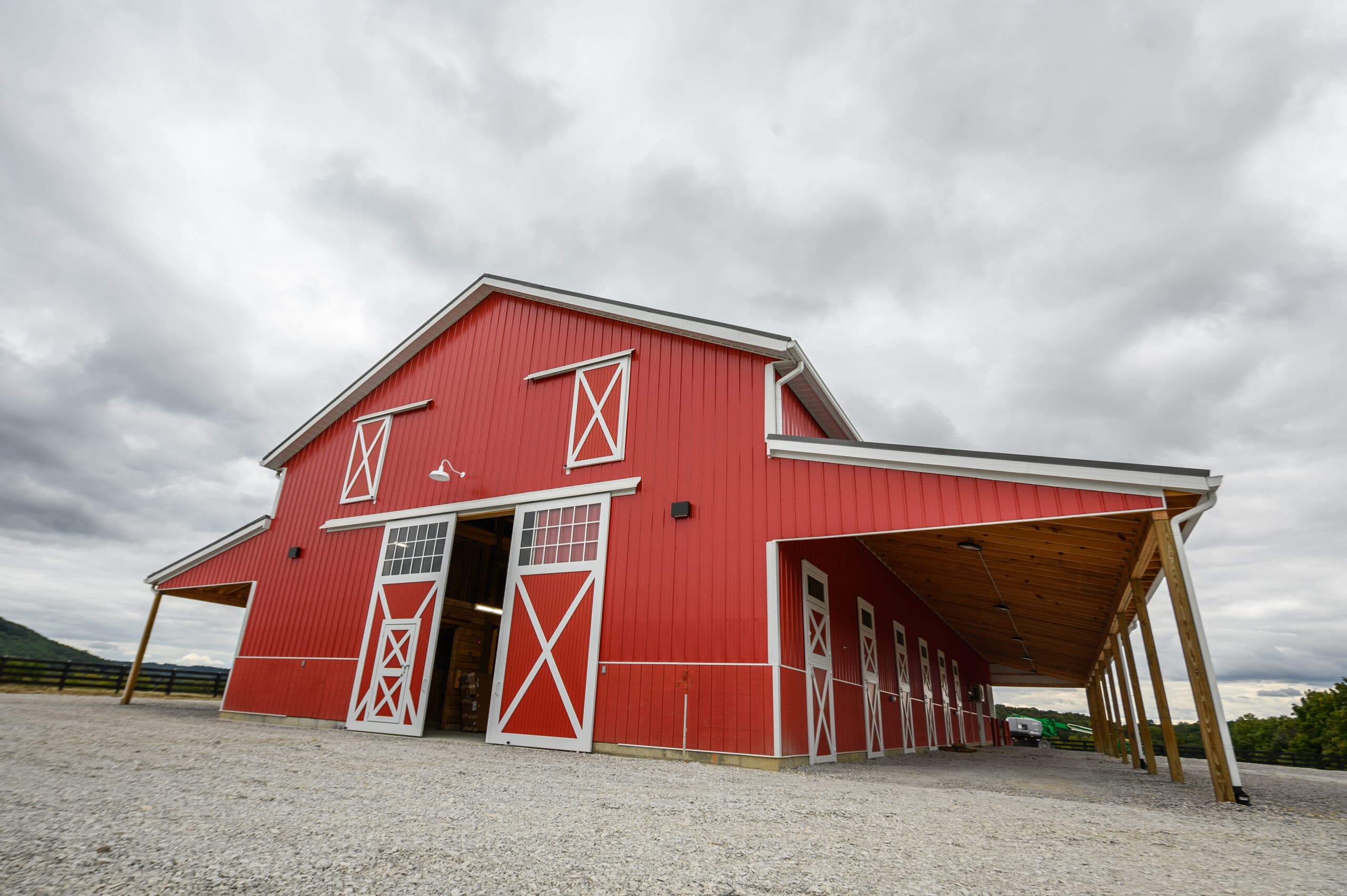 A picture of the new horse barn from the outside. The barn is red.