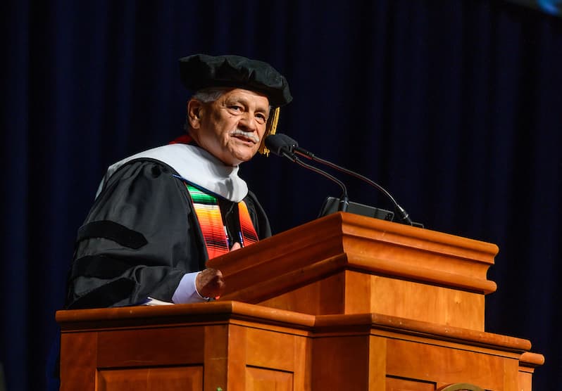 Photo of Tom Espinoza speaking at Berea College's 2023 May Commencement ceremony.