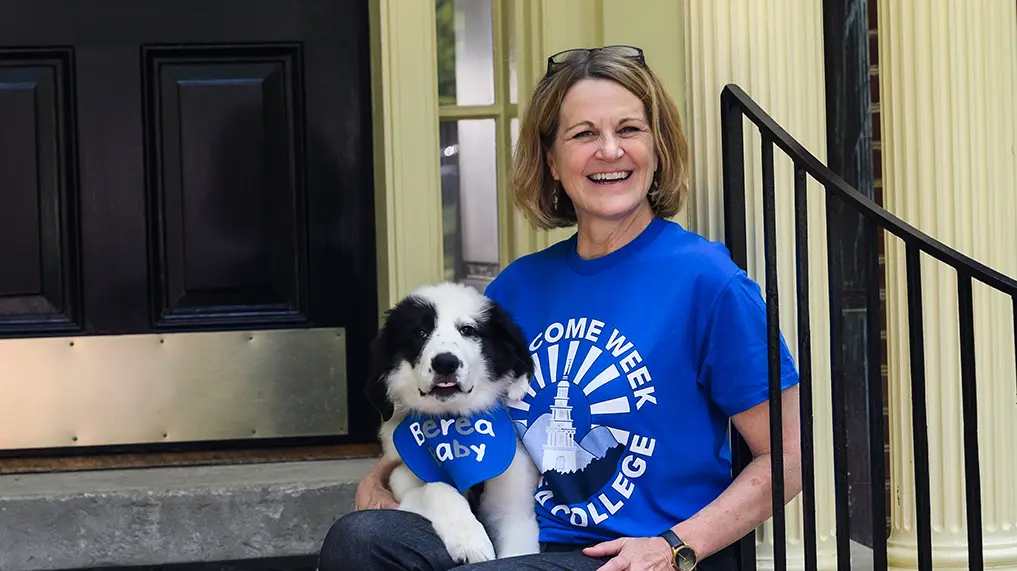 Dr. Cheryl Nixon with her new puppy on the porch of the President's Home