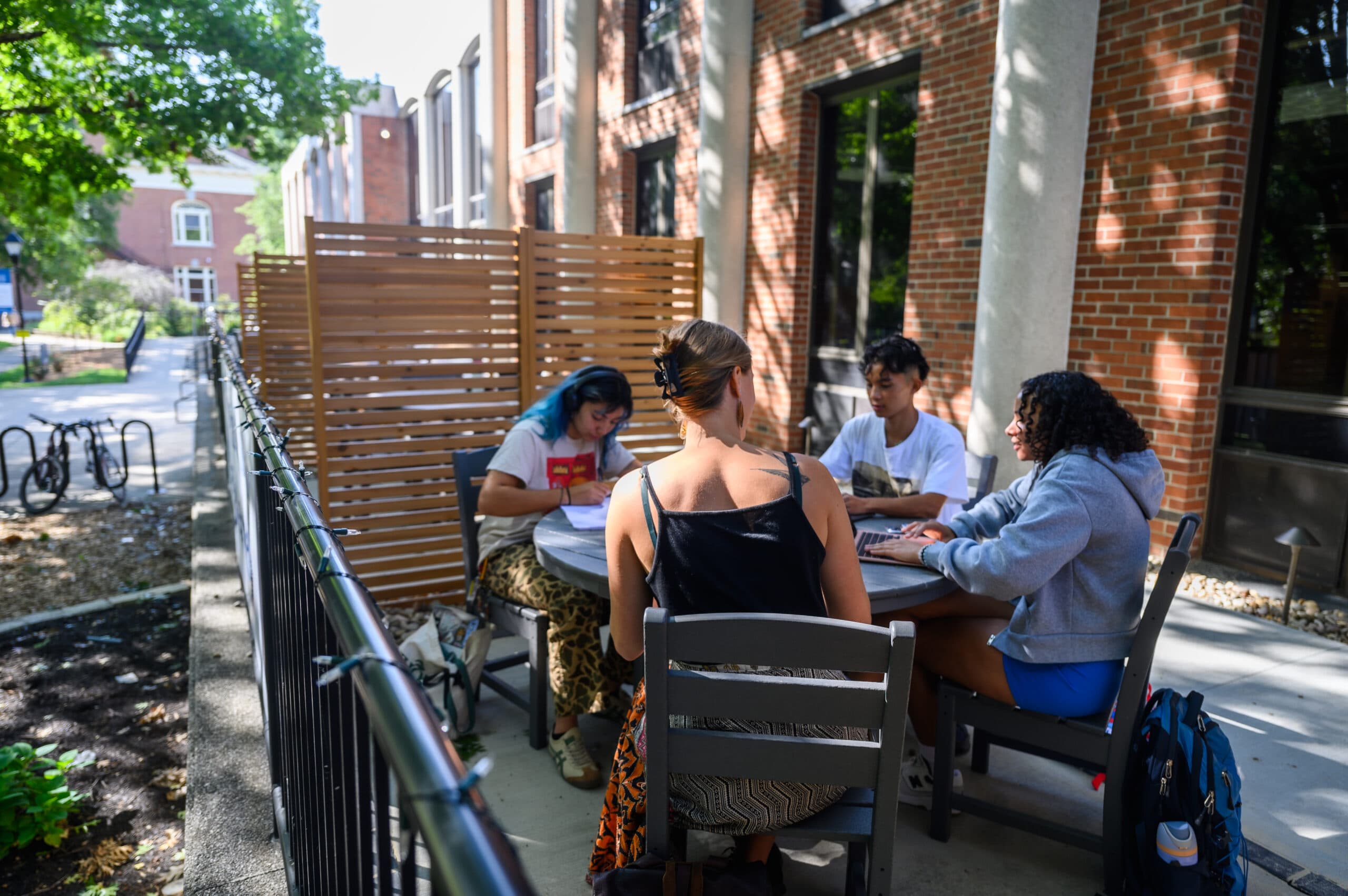 Berea College students sit outside the library
