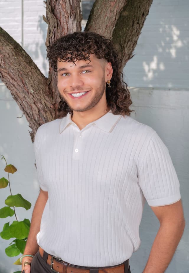 Berea College Admissions Associate, Bashiri Sawyer, standing in front of a tree trunk.