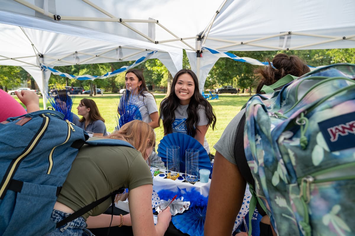 Kimberly smiles at the camera during Giving Day candy bar event.