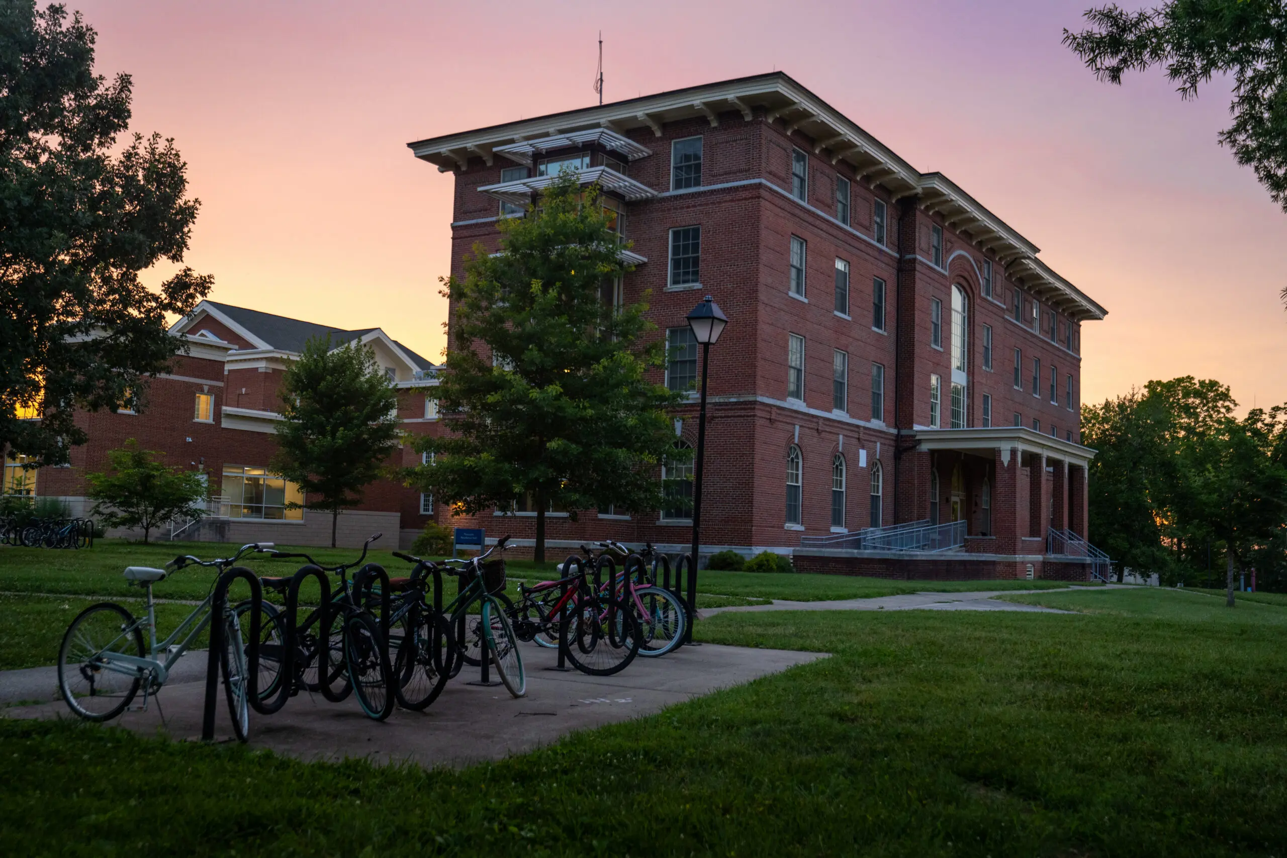 A sunset shot of a bike rack and a building on Berea's campus.